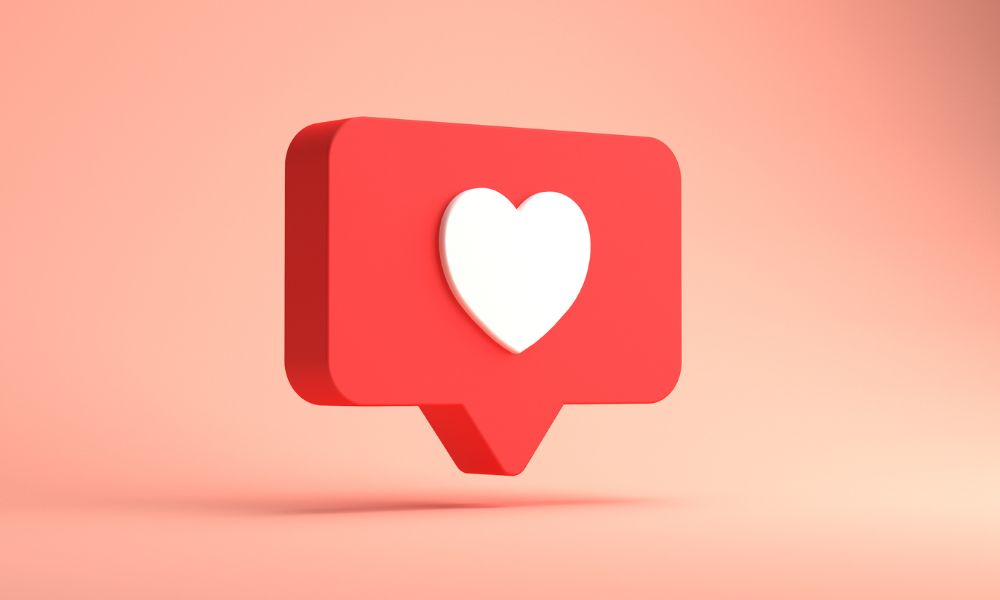 A red speech box with a white heart in the middle, against a peach background. For blog: Instagram Marketing